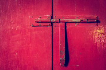red metal door closed with door handle lock