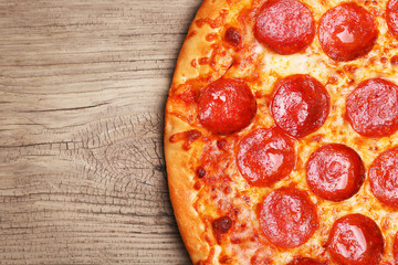 American Pepperoni Pizza on wooden background