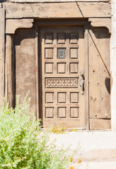 Old paneled ornate wooden door.