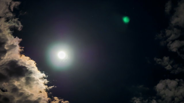Moon moving between Clouds in the night Time lapse