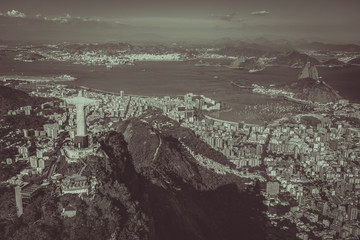 Aerial view of Christ and Botafogo Bay from high angle. awide angle with desaturated colors