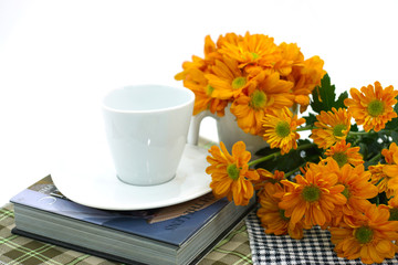 orange chrysanthemum and coffee cup