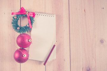 Empty paper note with Christmas balls on wooden background,Chris
