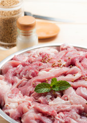 fresh raw pork with spices on cutting board
