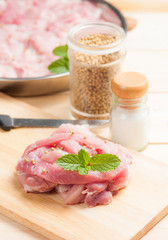 fresh raw pork with spices on cutting board
