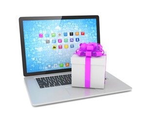 Gift box with ribbon on laptop keyboard