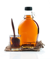maple syrup in glass bottle on white background