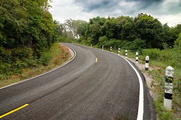 Empty curved road to the mountain.