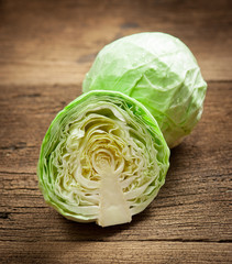 cabbage and cutted cabbage on wooden