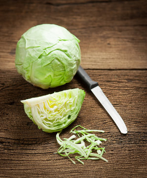cabbage and cutted cabbage on wooden