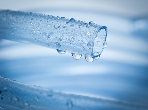 Drops Of Water Drip From Blue Garden Hose