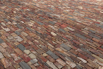 Old wall/pavement made of different bricks