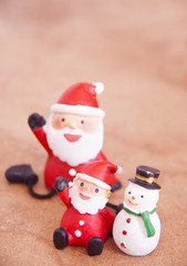 Santa Claus doll with Christmas ornaments background