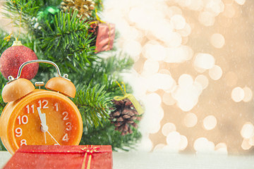 Christmas present celebration time orange clock and christmas tree.