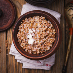 Freshly cooked buckwheat porridge in a clay pot, top view