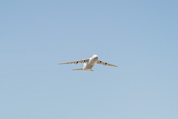Ruslan (Condor) the world largest cargo strategic airlift jet airplane flies against blue sky background
