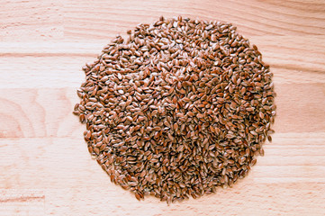 Flax seeds on  wood