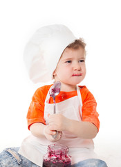 baby chef eating jam isolated on white background