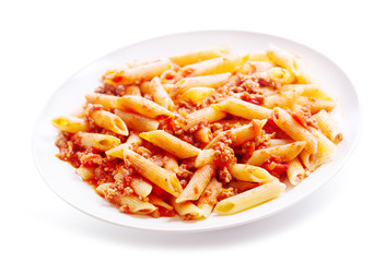 plate of penne pasta bolognese on white background