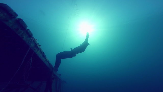 Freediver Experiencing a super Slow free fall Underwater Falling of a Platform into a Quarry.