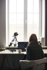 Workplace with open laptop with black screen  on modern wooden desk, angled notebook on table in home interior, filtered image.
Photographer, camera