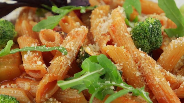 Red penne pasta with tomato sauce and vegetables