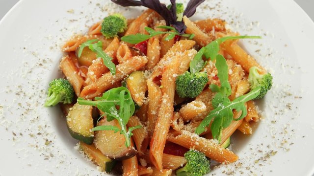 Red penne pasta with tomato sauce and vegetables (loop)