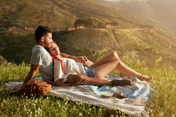 Couple relaxing at picnic on a summer day