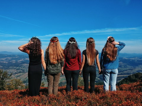 Modern hippy girls on the top of mountain