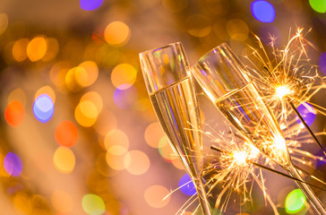 Glasses of champagne with bright gold background © Lukas Gojda