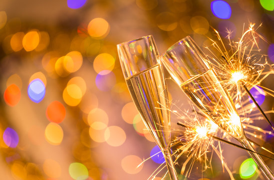 Glasses of champagne with bright gold background