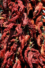Dried paprika in red orange shades in a market stall