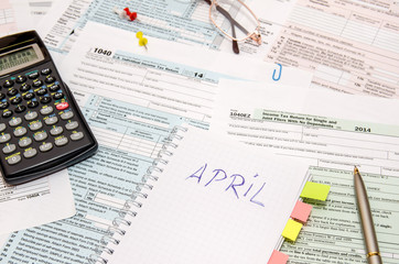 Naklejka na ściany i meble Tax forms with pen, calculator, glasses