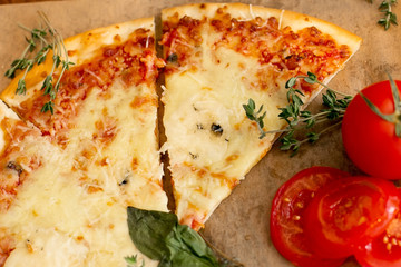 Appetizing Pizza Margherita with tomatoes on baking paper