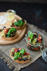 Toast with baked eggplant with tomatoes, garlic