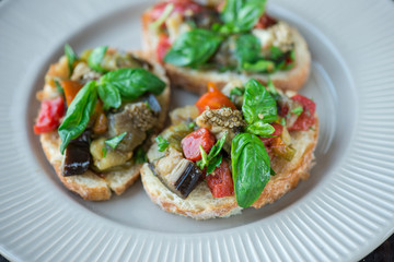 Toast with baked eggplant with tomatoes, garlic