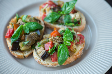 Toast with baked eggplant with tomatoes, garlic