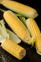 Organic sweet corn on wooden table. Selective focus.