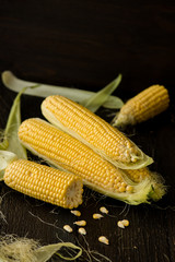 Organic sweet corn on wooden table. Selective focus.