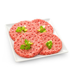 Four raw hamburger slices on white plate