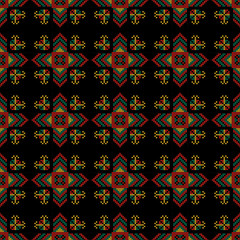 The cross-stitch. Yellow, red, green, and black colors.