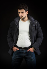 Man in black jacket, studio shot, dark background