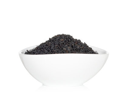 Black sesame seeds in the bowl isolated on white background