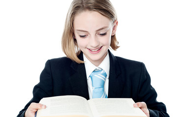 Cute business girl studying a book