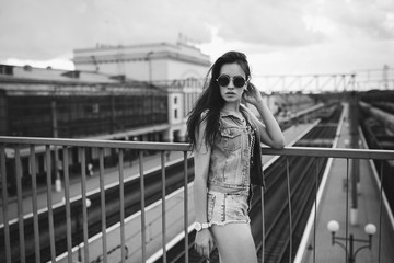 Young sexy woman portrait. Stylish hippie girl posing on the street with interested bohemian look. Vintage lifestyle trendy portrait. Photo toned style Instagram filters.