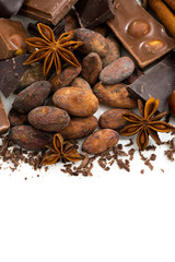 background with cocoa beans, chocolate and spices, closeup
