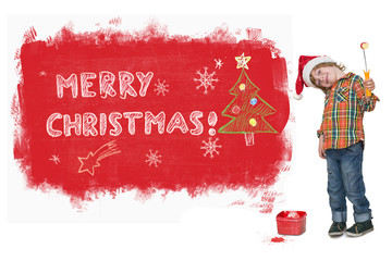 Little boy with Santa hat painting red Christmas banner on the w