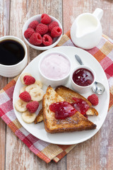 sweet toasts with fresh raspberry, jam and yoghurt for breakfast