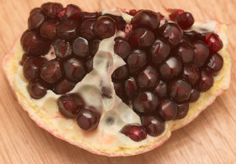 ripe pomegranate on a wooden background