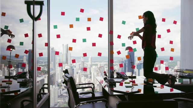 Latin american woman working as secretary in modern office with beautiful sight on the city, sticking adhesive notes with tasks on skyscraper window. The girl feels stressed and overwhelmed. 